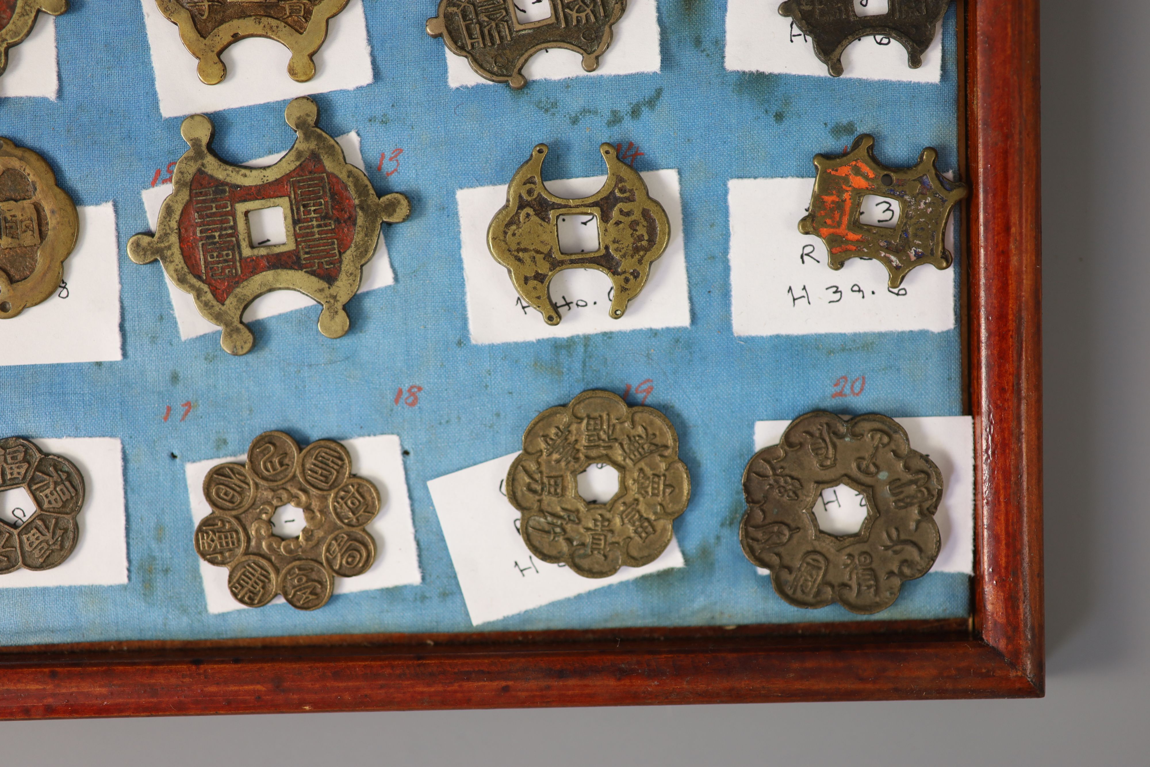 A group of 99 Korean bronze and metal amulets or charms, 19th/20th century